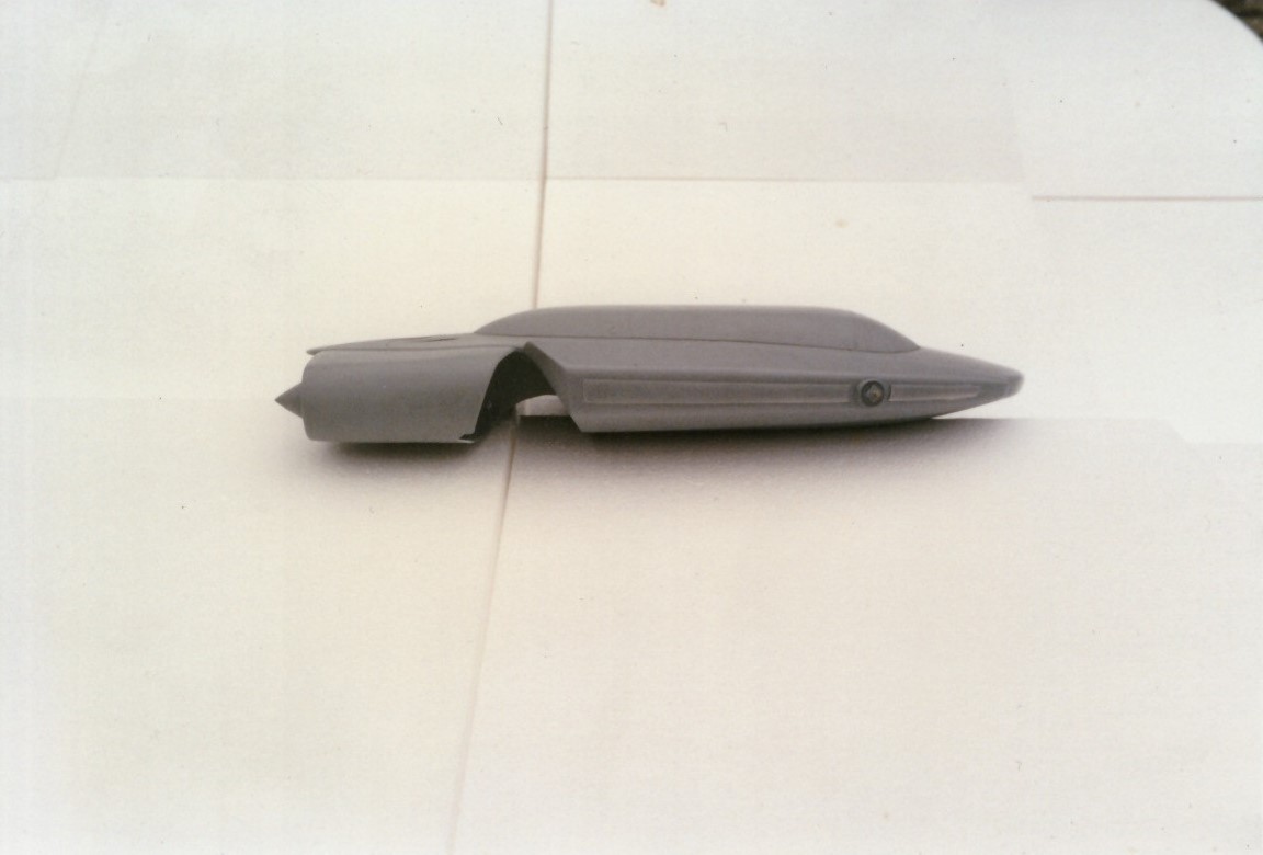 Large white polystyrene form with layered contours resembling a Naboo speeder prototype, staged in a workshop