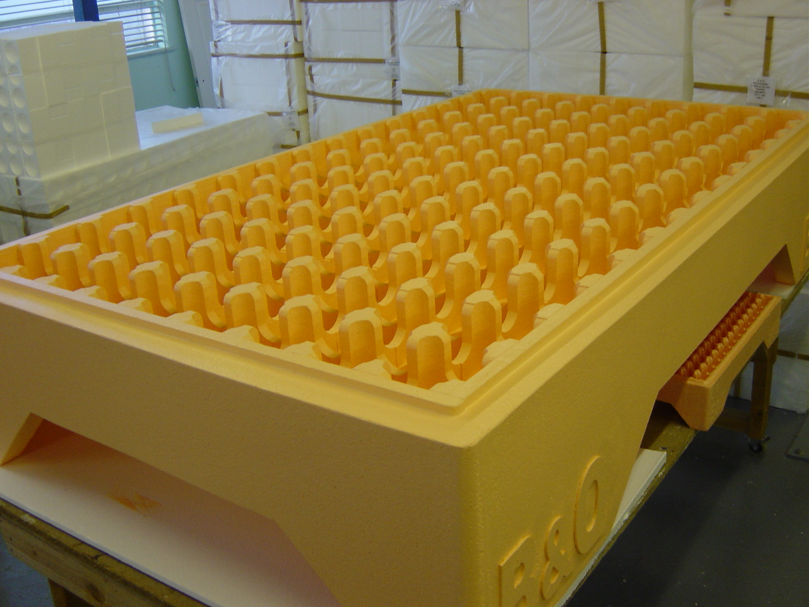 Oversized polystyrene prop resembling a B&Q seed tray with grid of U-shaped cut-outs