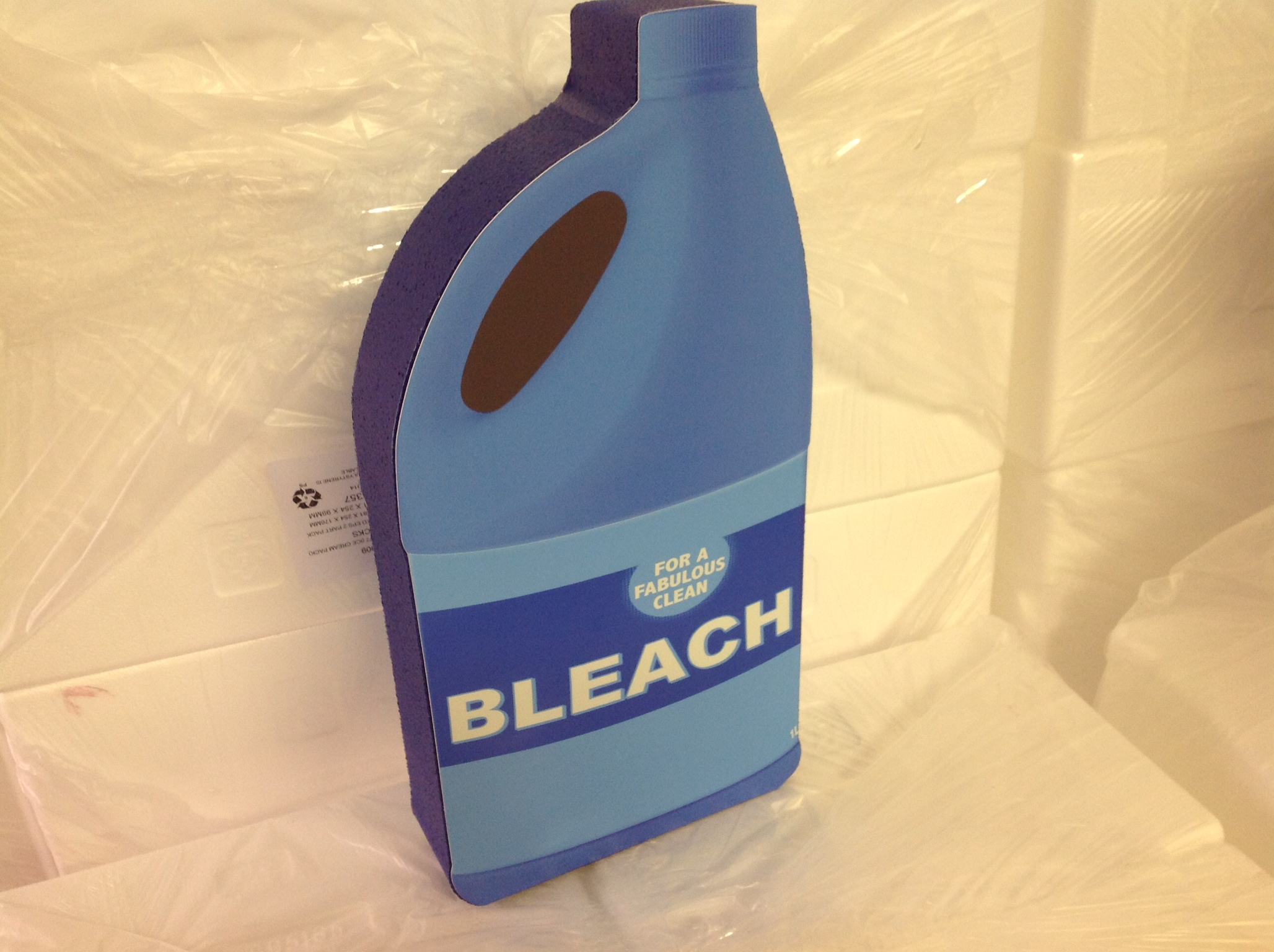 Polystyrene prop shaped like a bleach bottle labelled FOR A FABULOUS CLEAN BLEACH
